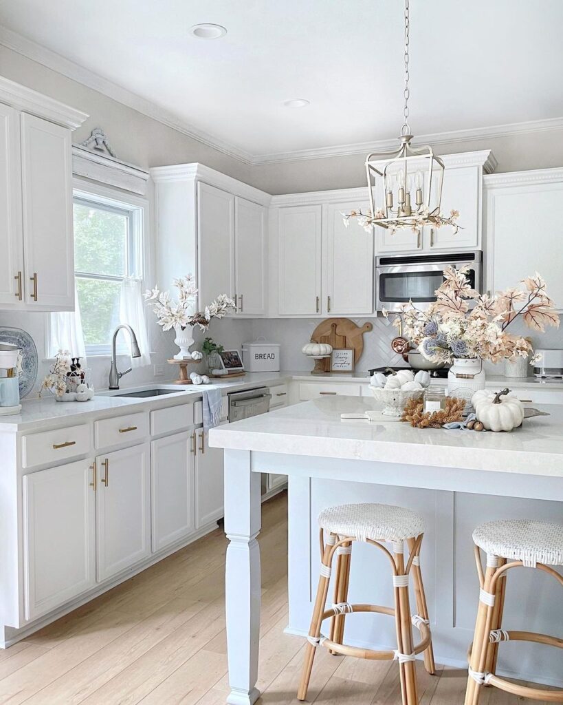 White kitchen, fall centerpiece, rattan stools