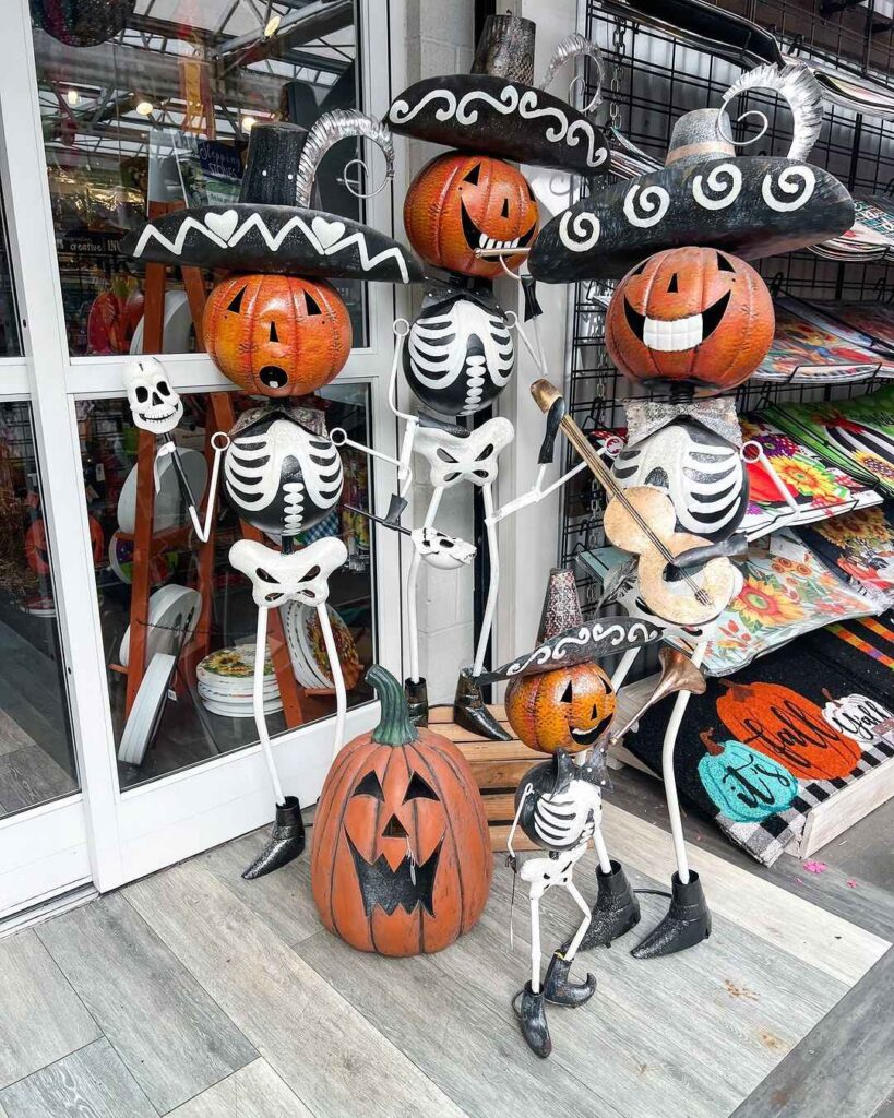 Skeleton figurines with pumpkin heads wearing sombreros