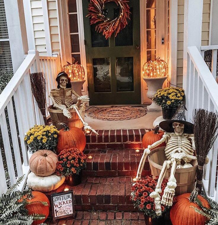 Festive Halloween porch with skeletons and pumpkins