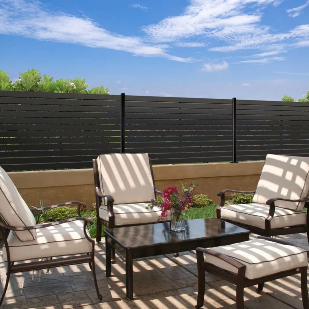 Black slat fence with rooftop patio furniture