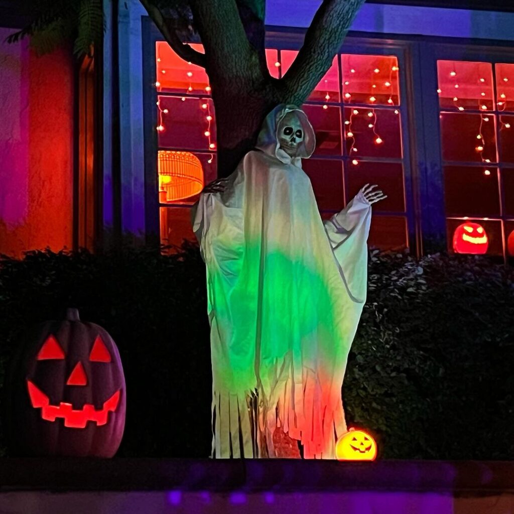 Colorful ghost decoration with glowing pumpkins