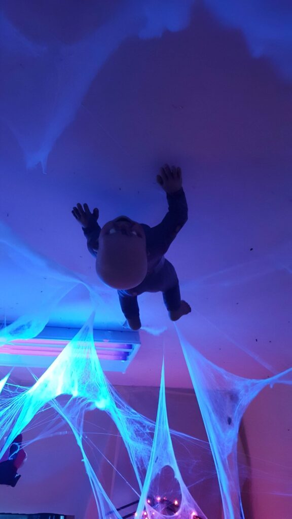 Floating doll above glowing blue cobwebs