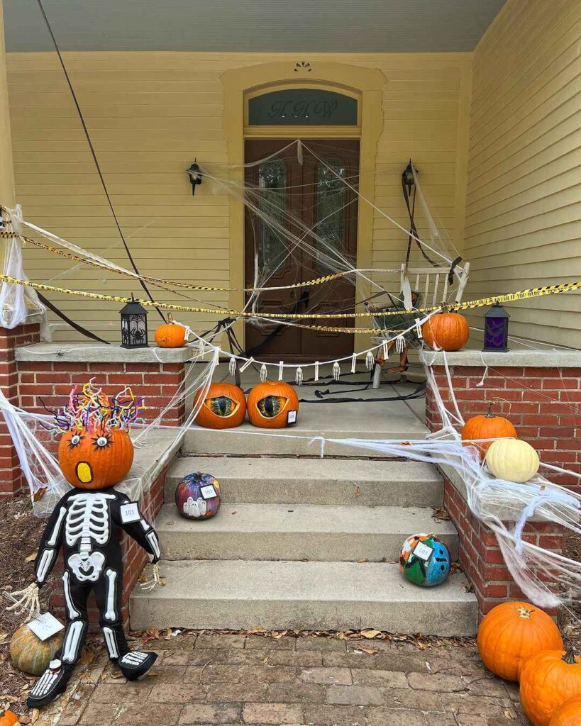 Halloween-decorated porch with pumpkins and skeleton