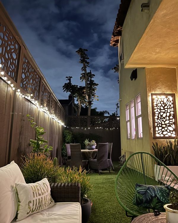 Illuminated patterned fence cozy night patio