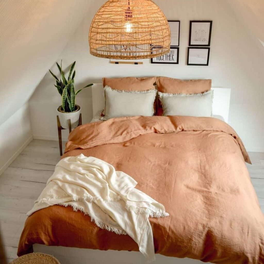 Terracotta bedding, rattan light, minimalist decor