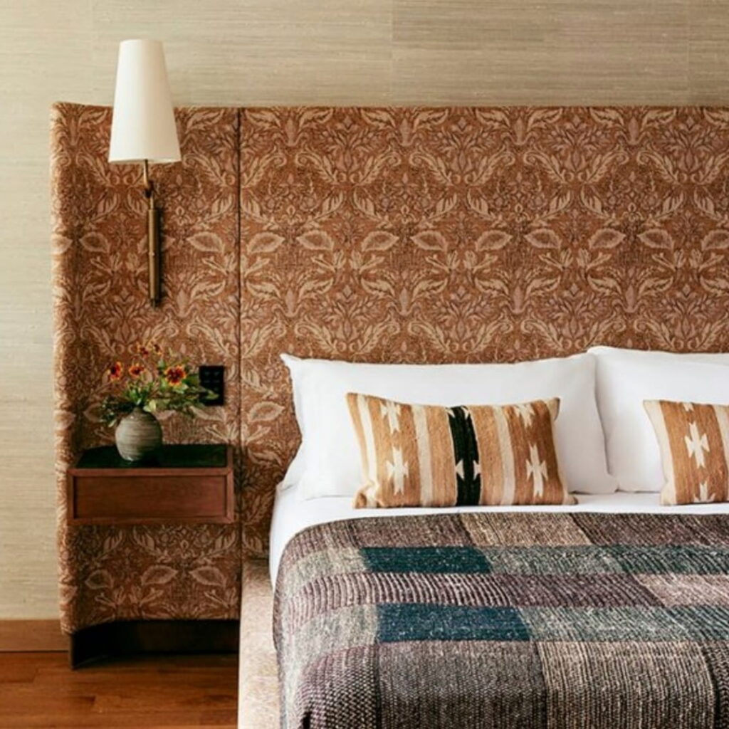 Patterned headboard, ethnic pillows, textured bedding