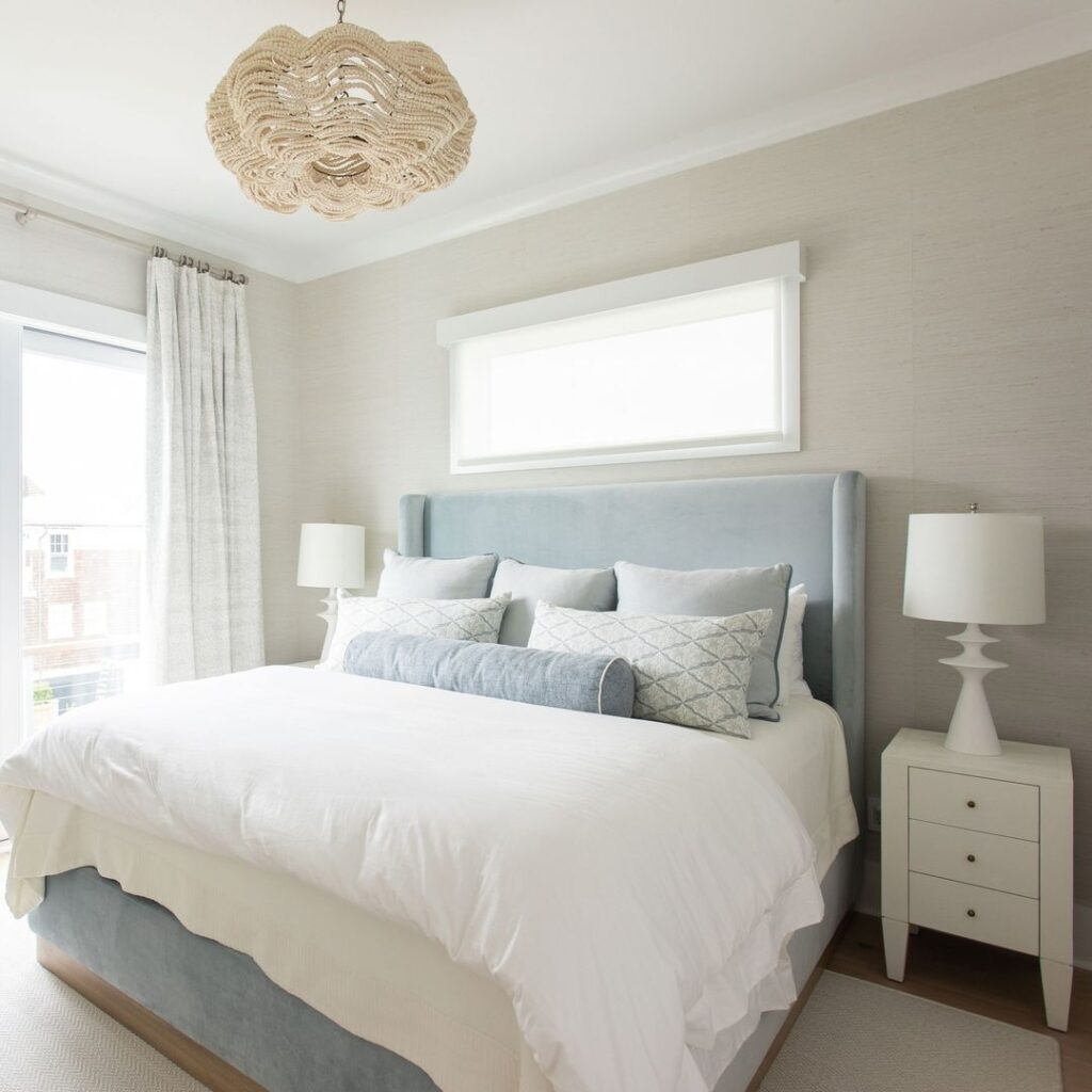 Serene bedroom with blue headboard, white bedding