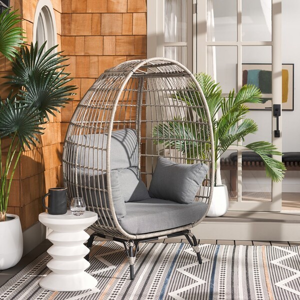 Wicker egg chair with tropical plants indoors