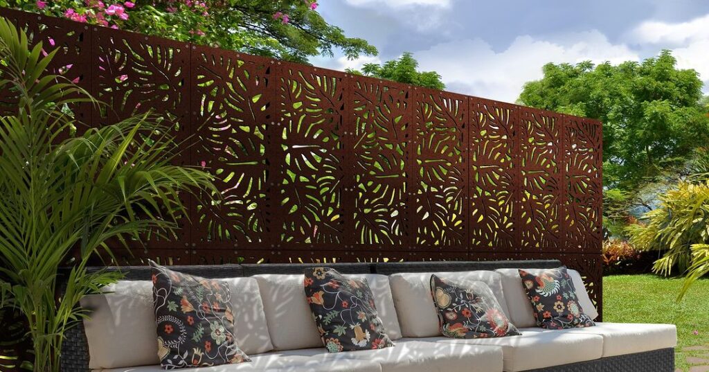 Decorative palm-patterned fence behind outdoor sofa