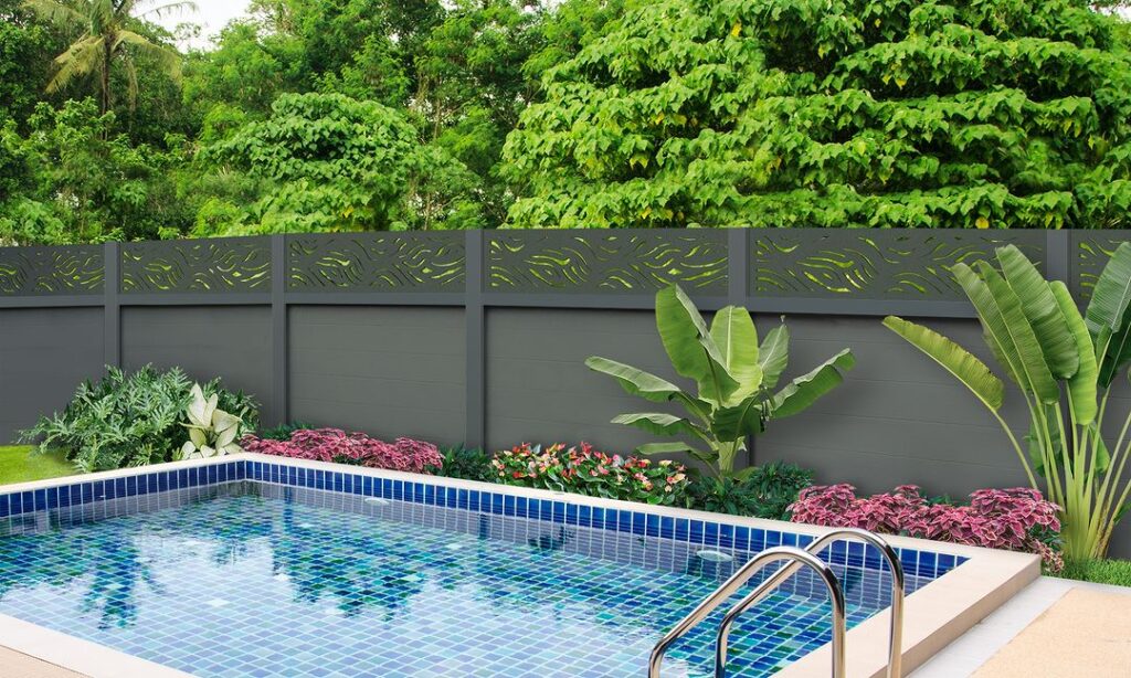 Pool with decorative fence and tropical plants