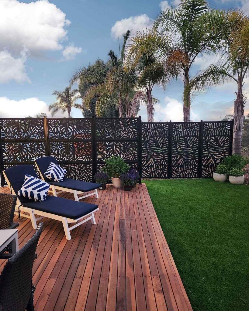 Deck with decorative privacy screens and loungers