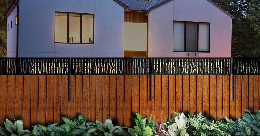 Wooden fence with decorative metal topper