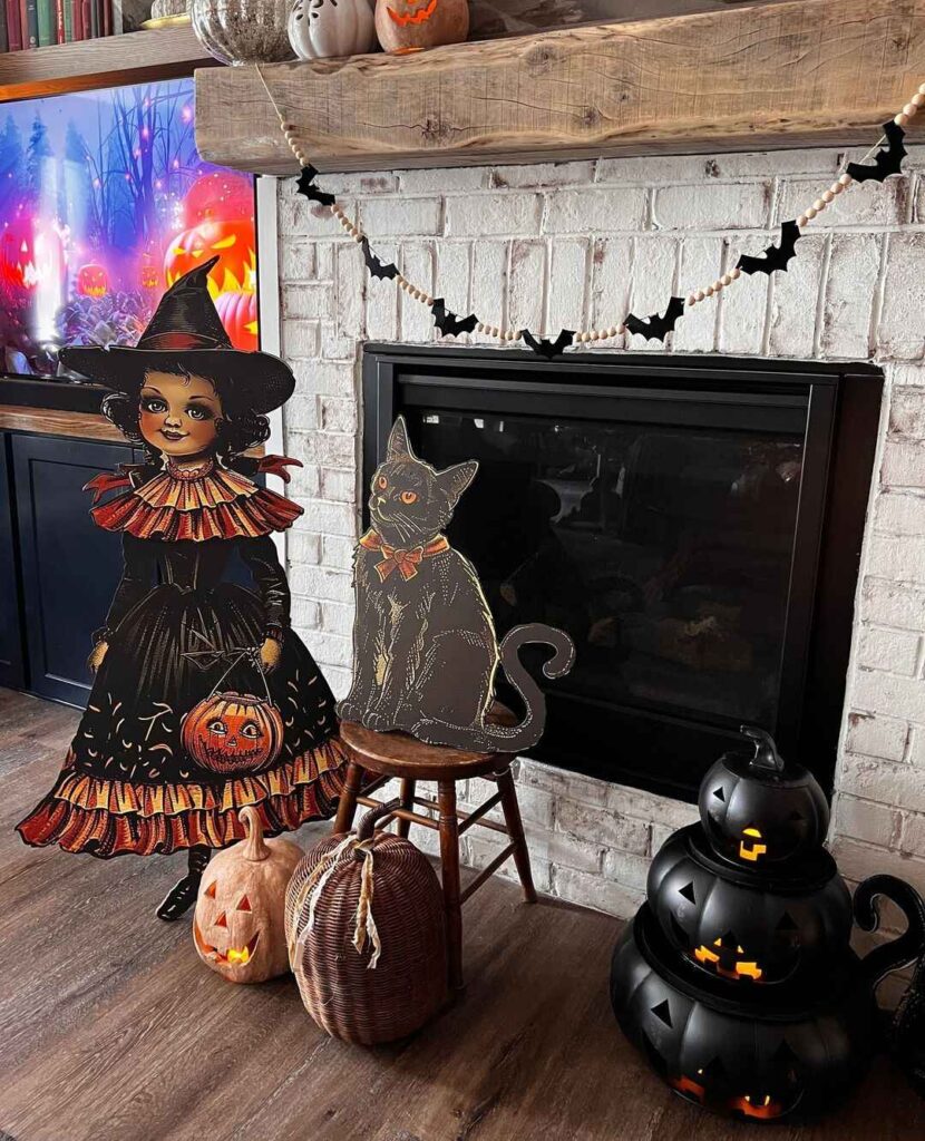 Halloween fireplace with witch and cat decorations