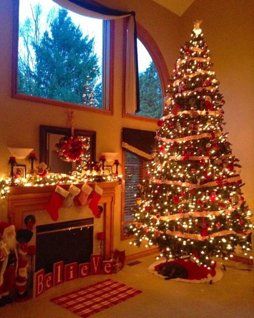 Lit mantel, decorated tree, "Believe" sign