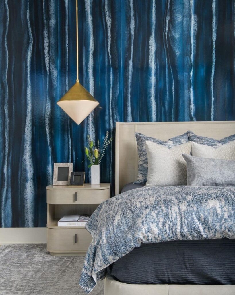 Blue waterfall wallpaper, neutral furniture, brass light