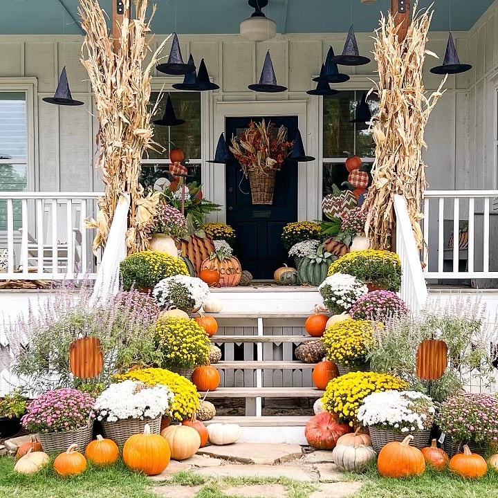 Witch-themed porch autumn decor pumpkins mums