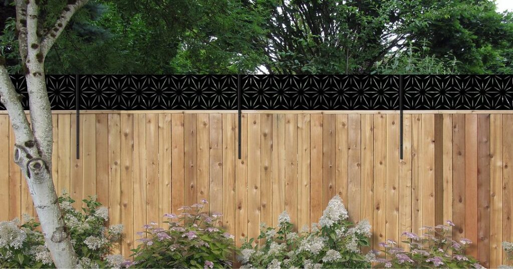 Wooden fence with decorative black lattice top