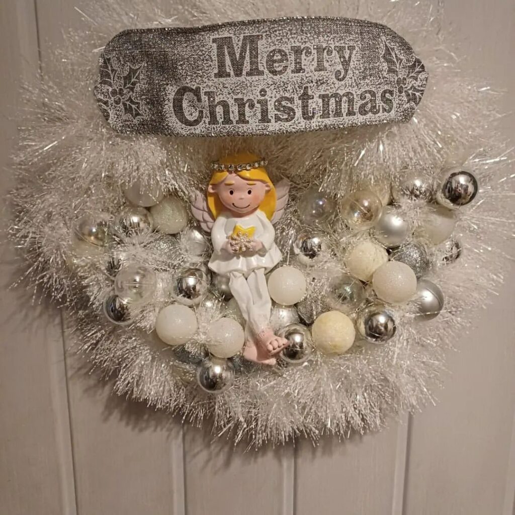 White tinsel wreath with angel and ornaments