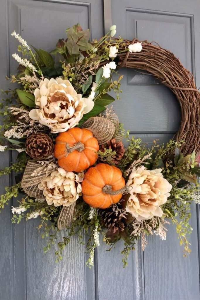 Fall wreath with pumpkins flowers and pinecones