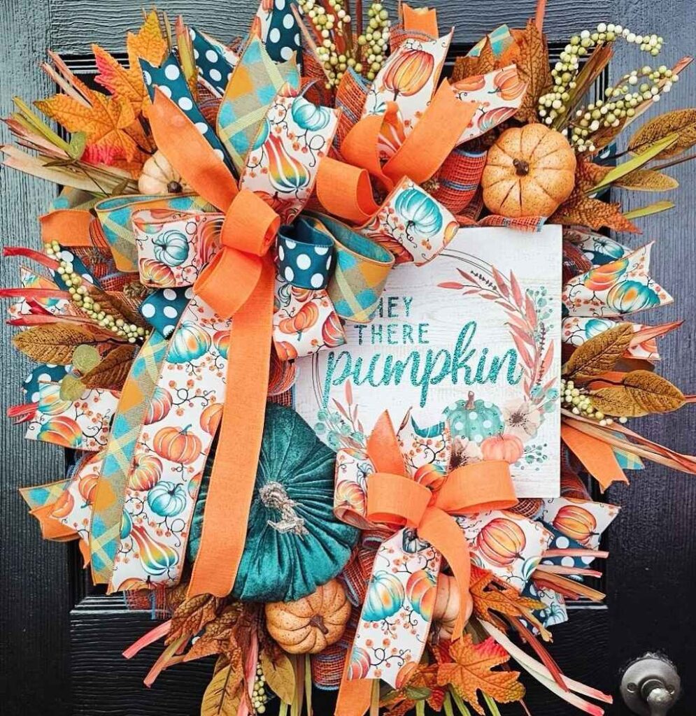 Colorful autumn wreath with pumpkins and teal accents.