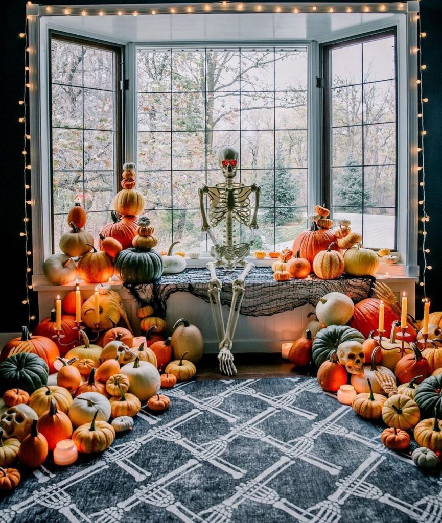 Elegant Halloween window display with pumpkins, skeleton.