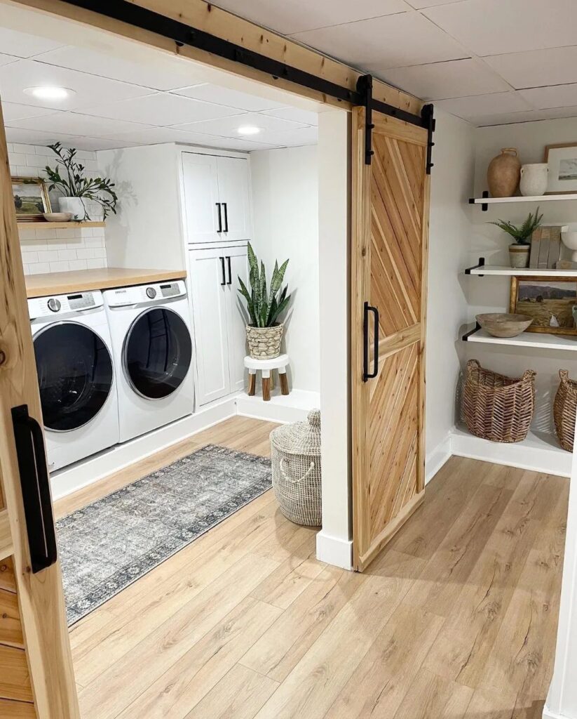 Laundry room with barn door and modern appliances.