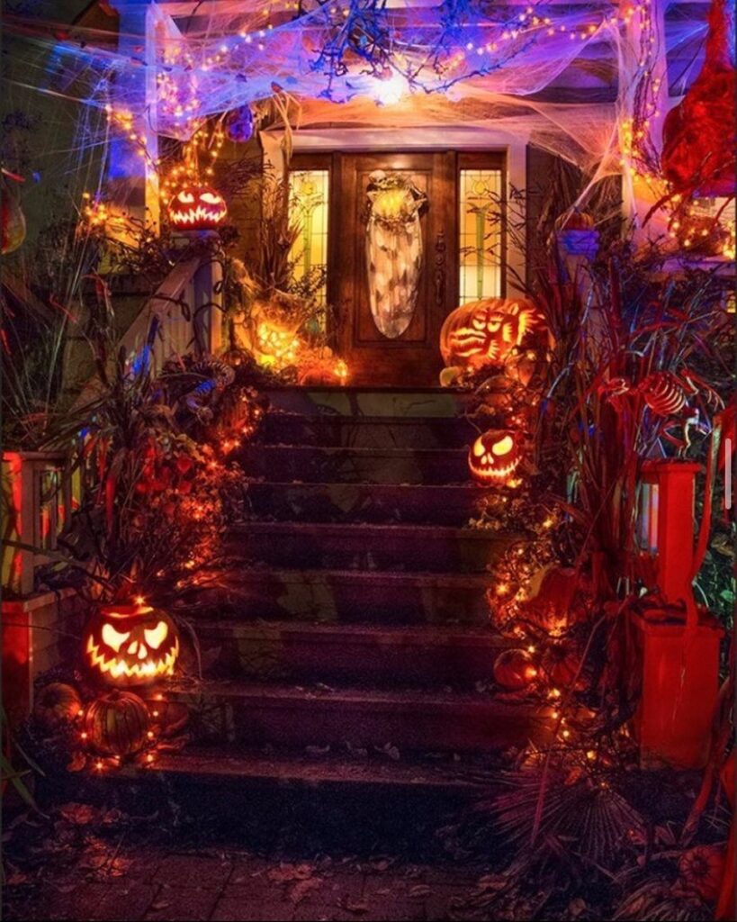 Illuminated spooky Halloween porch with pumpkins