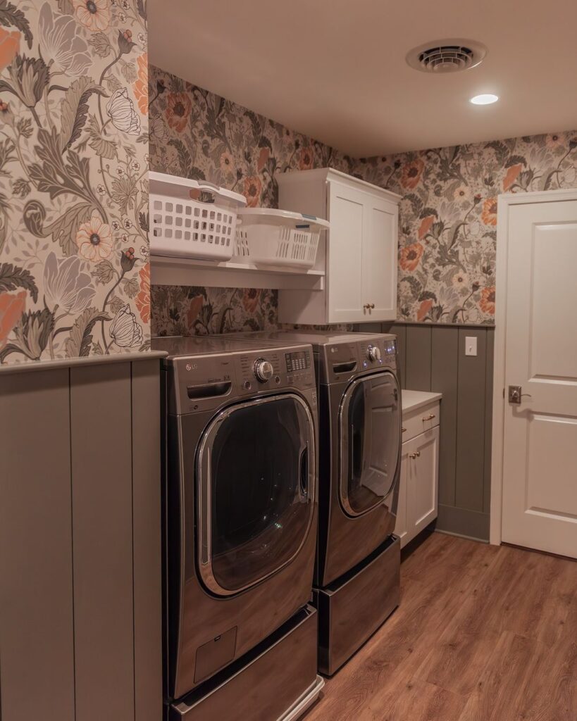 Laundry room with floral wallpaper and modern appliances.