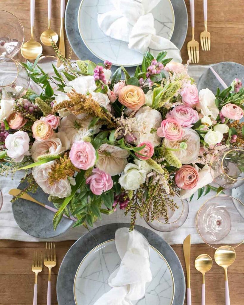 Thanksgiving table with pink floral centerpiece and gold accents