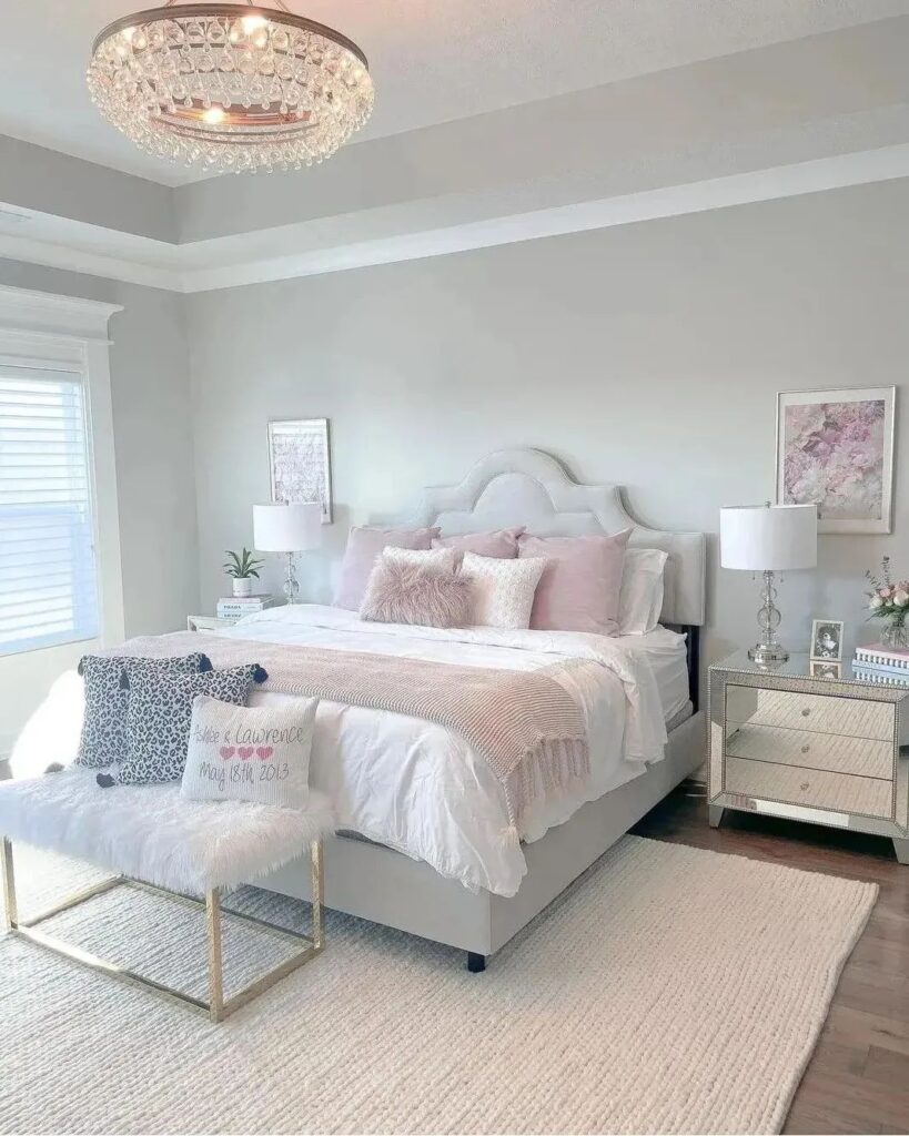 Elegant bedroom with crystal chandelier and pink accents