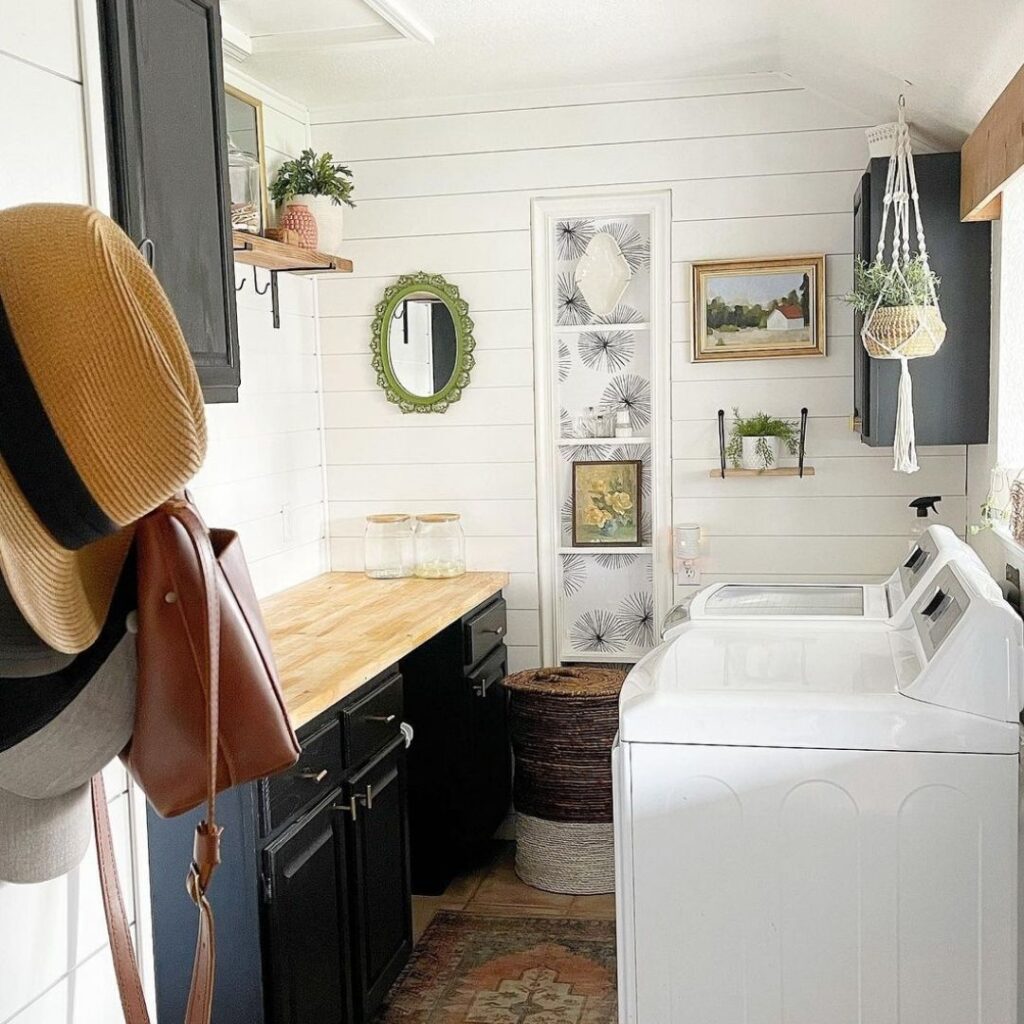 Eclectic laundry room with white washer, wooden counter, and bohemian decor.