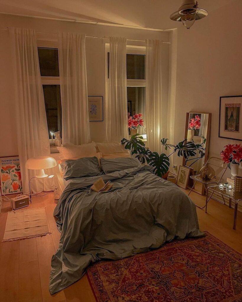 Cozy bedroom with dark bedding plants and warm lighting at night