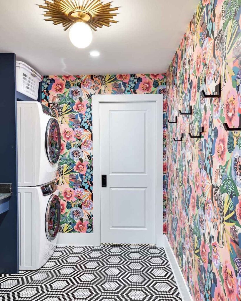 Laundry room with colorful floral wallpaper and patterned floor.