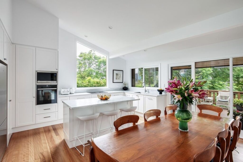 Bright kitchen-dining area with outdoor views.