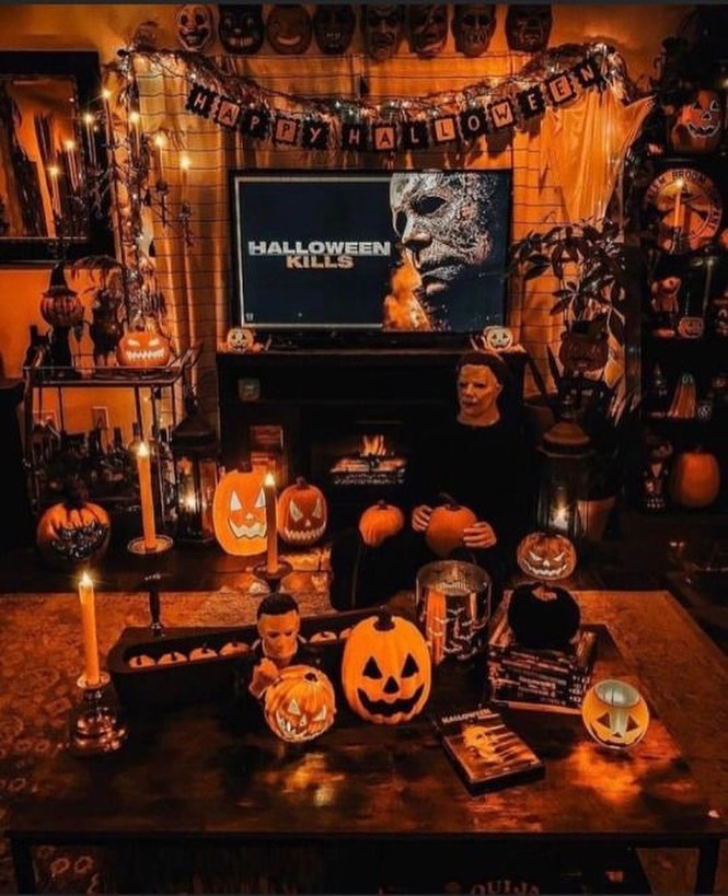 Halloween-decorated room with horror movie posters and pumpkins