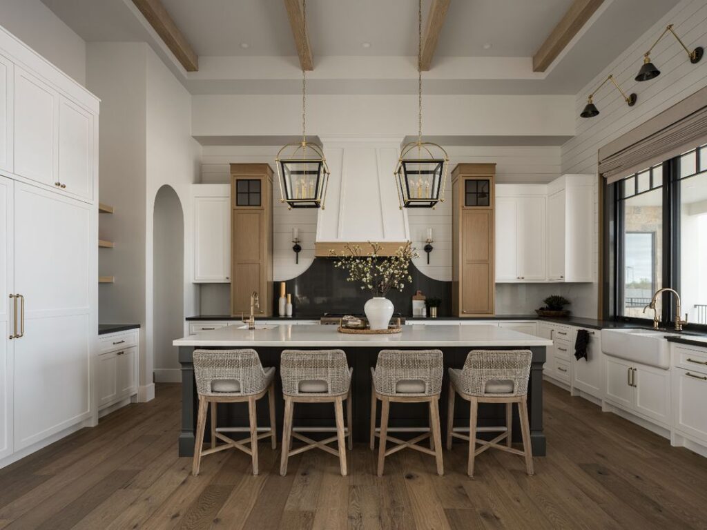 Luxurious beige kitchen with island, pendant lights, and coastal-inspired decor.