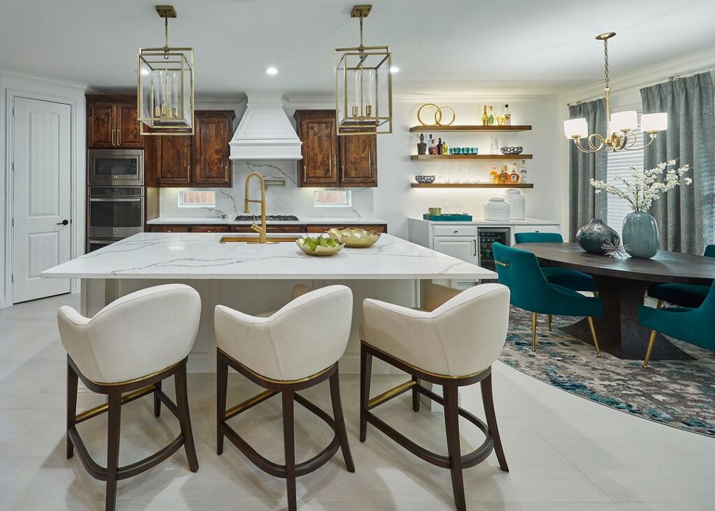 Modern kitchen with dark wood cabinets white island and teal accents.