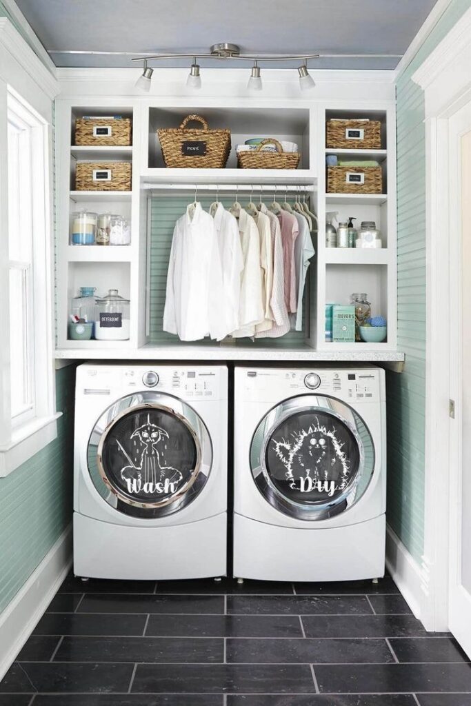 Organized laundry room with mint walls, white shelving, and decorated appliances.