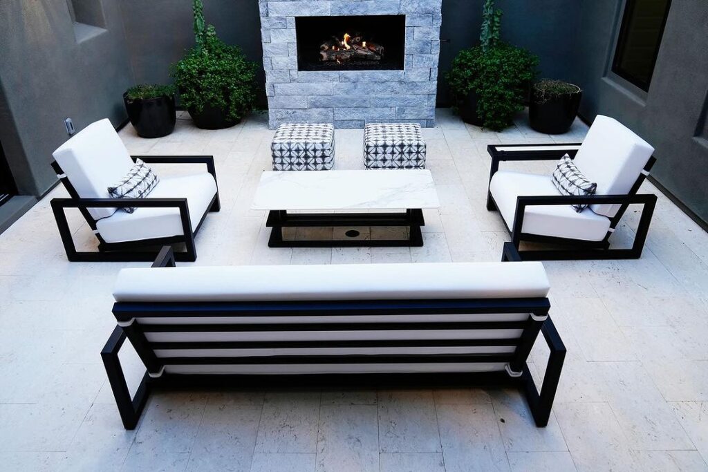 Chic monochrome patio with fireplace lounge