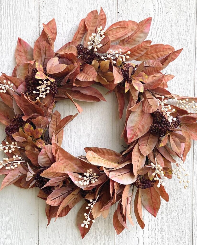 Wreath with copper-colored leaves white and burgundy berries.