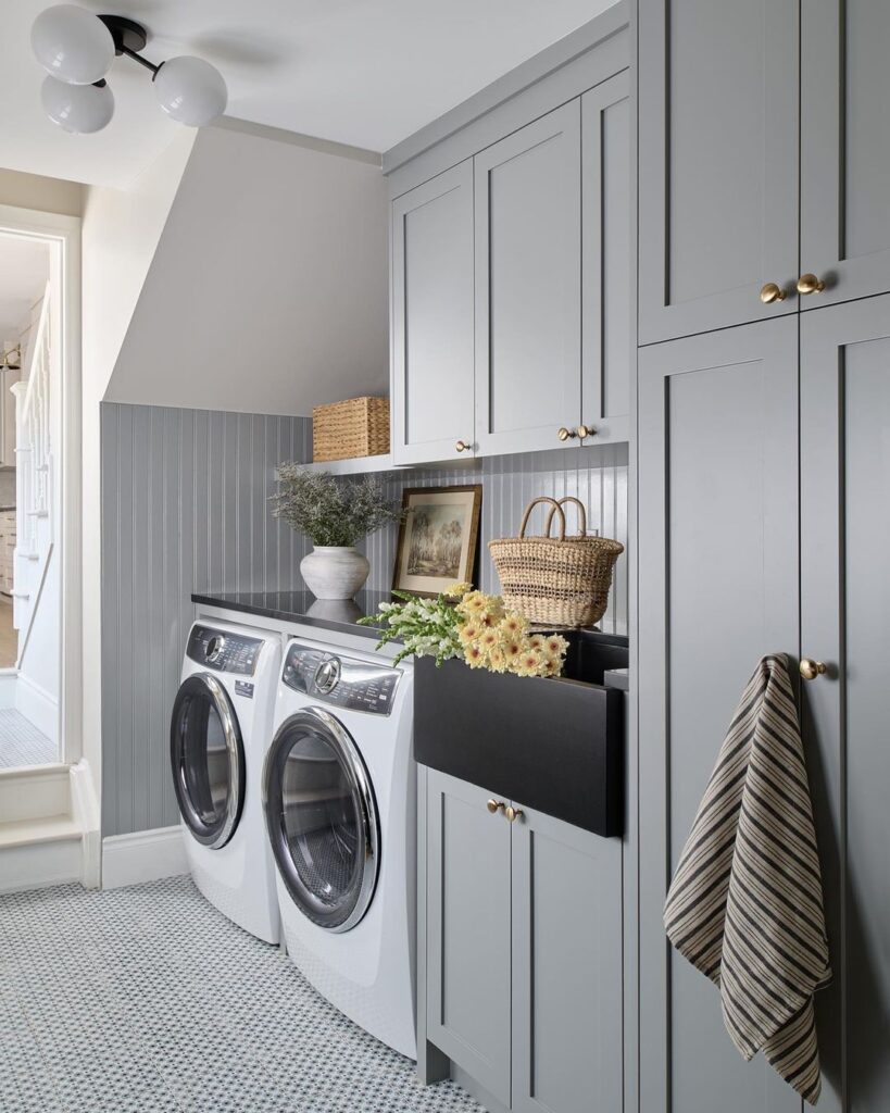 Gray laundry room with farmhouse touches and sloped ceiling