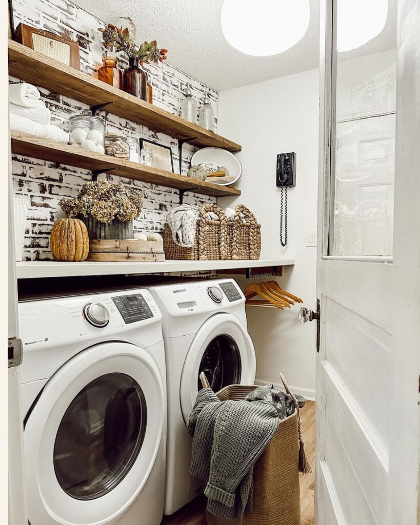 Compact laundry room with brick wallpaper and white appliances