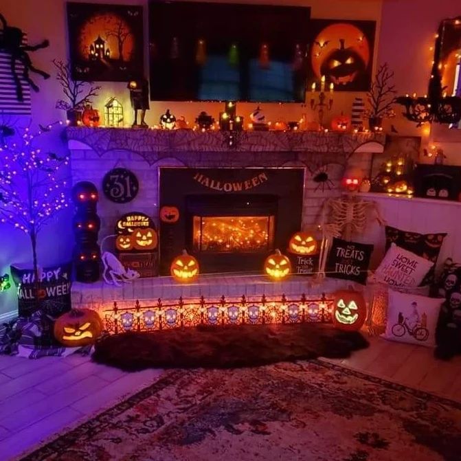 Festive Halloween living room with illuminated fireplace decorations.