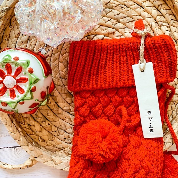 Red knit stocking with personalized tag and ornaments