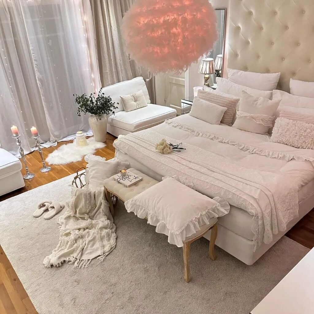 Luxurious white bedroom with pink fluffy light fixture