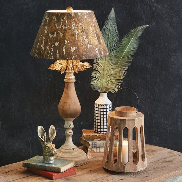 Rustic lamp with wooden lantern fern and rabbit figurine.