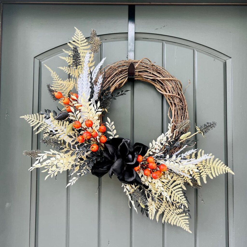 Modern fall wreath with ferns berries and black bow