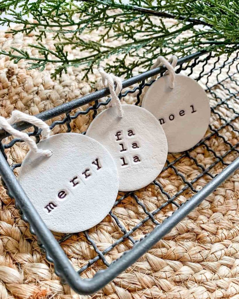 Handmade clay ornaments with festive words stamped