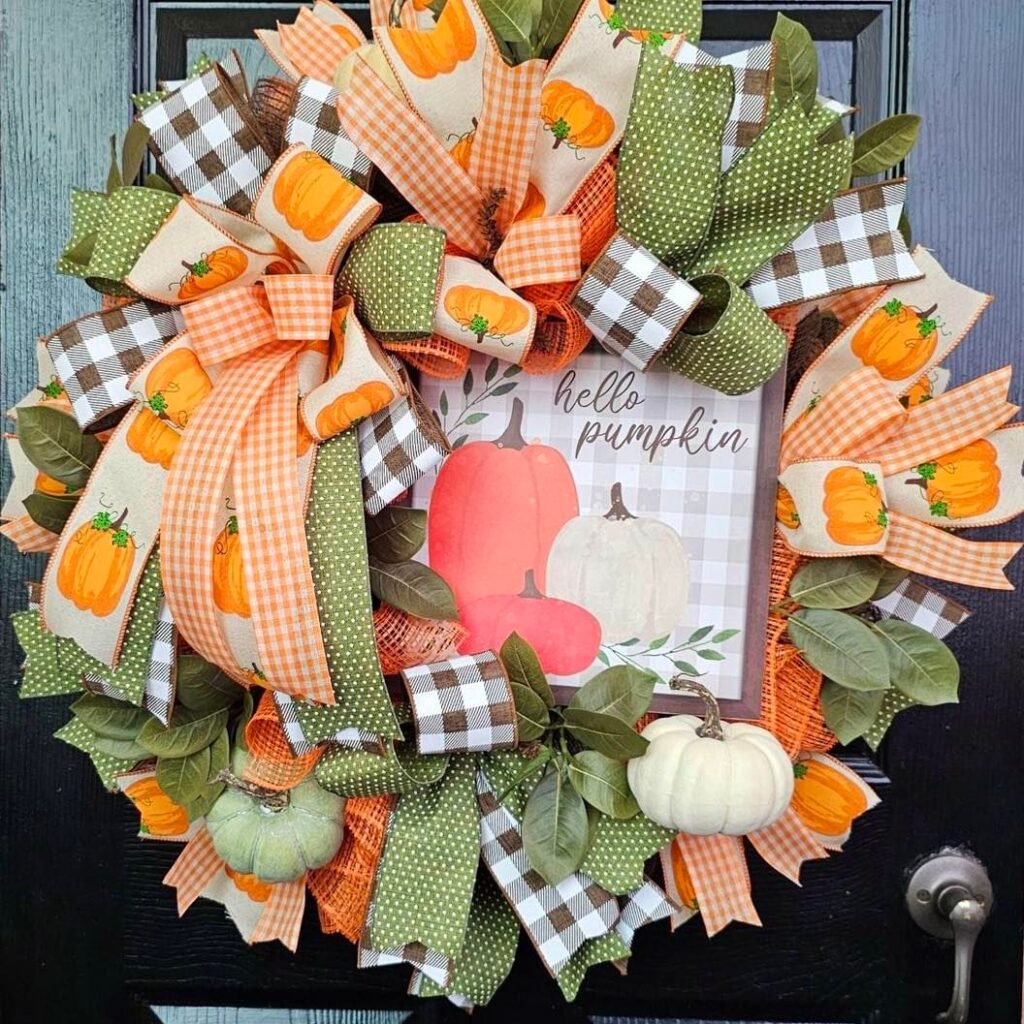 Colorful pumpkin-themed ribbon wreath for autumn.