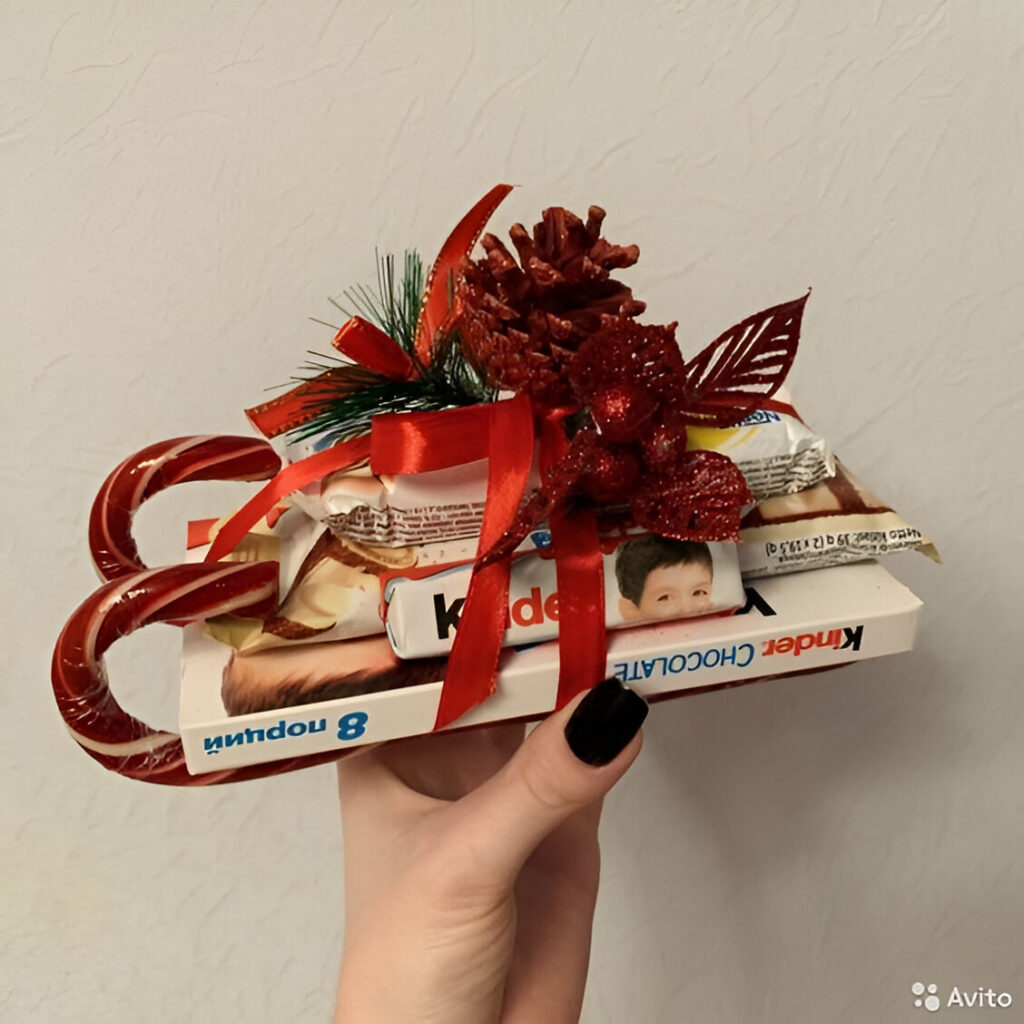 Hand holding chocolate bar sleigh with decorations